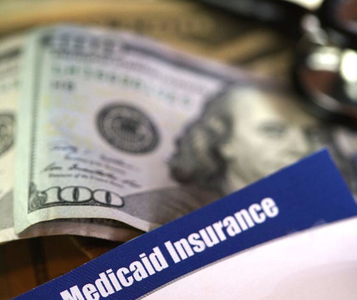 medicaid insurance card with money bills