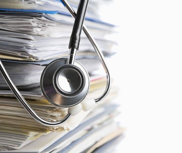 stack of medical records with stethoscope for post ACLU and NaphCare dispute exposure of inmate health records