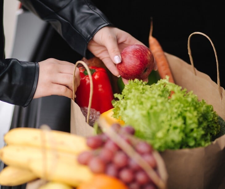 Image of a grocery bag with fresh fruit in it. 