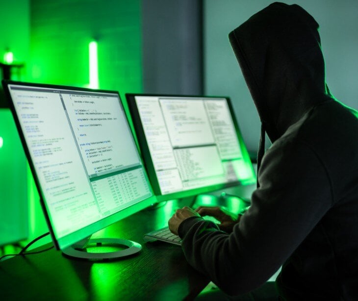 Image of someone on a computer for blog about Bankers Cooperative Group submits data breach notification to HHS-OCR