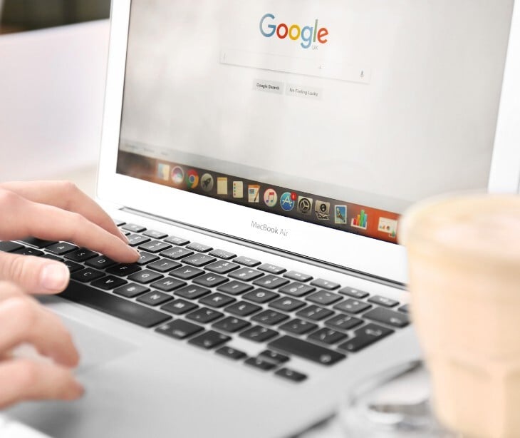 Image of someone on a laptop with Google open. 