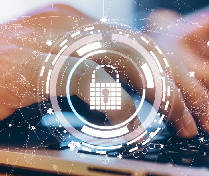 Image of someone typing on a computer, overlayed with a lock image. 