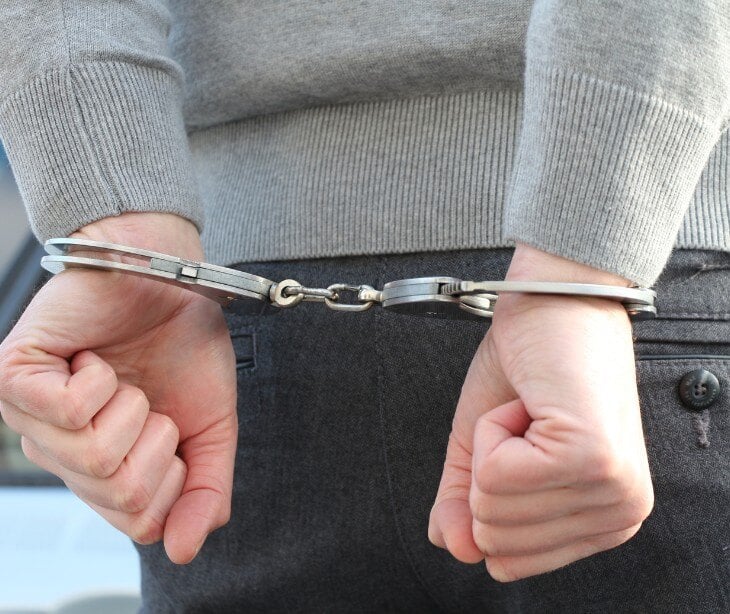 Image of hands in handcuffs.