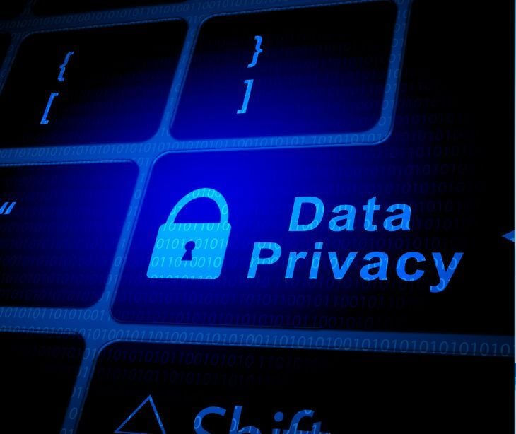 data privacy text and lock on keyboard in blue