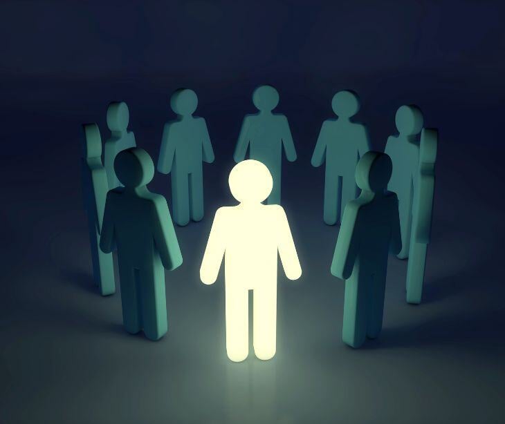 people figures in a circle with one lit up