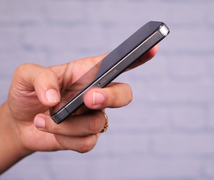 Image of an individual holding a smart phone. 