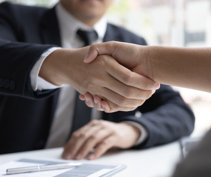 Image of two people shaking hands. 