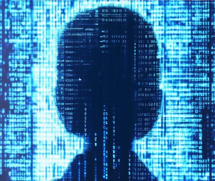 head figure in front of computer code