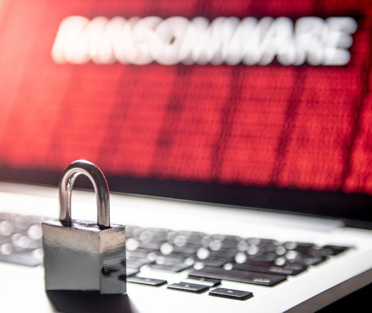 lock on keyboard with red screen reading ransomware