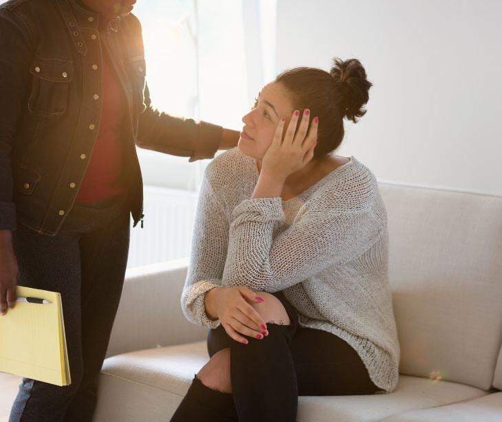 stressed woman speaking with another woman