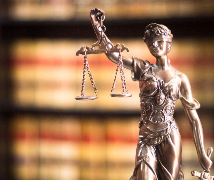 Image of statute holding scales to represent checks and balances.