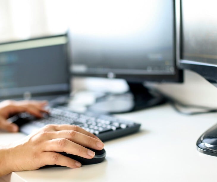 Image of someone on a desktop computer. 