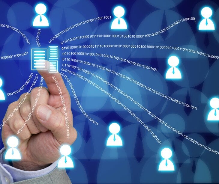 Image of person tapping a screen with profiles that represent data.