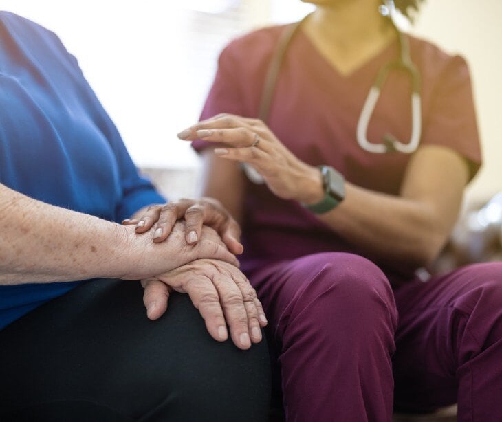 Image of a nurse talking to a patient. 