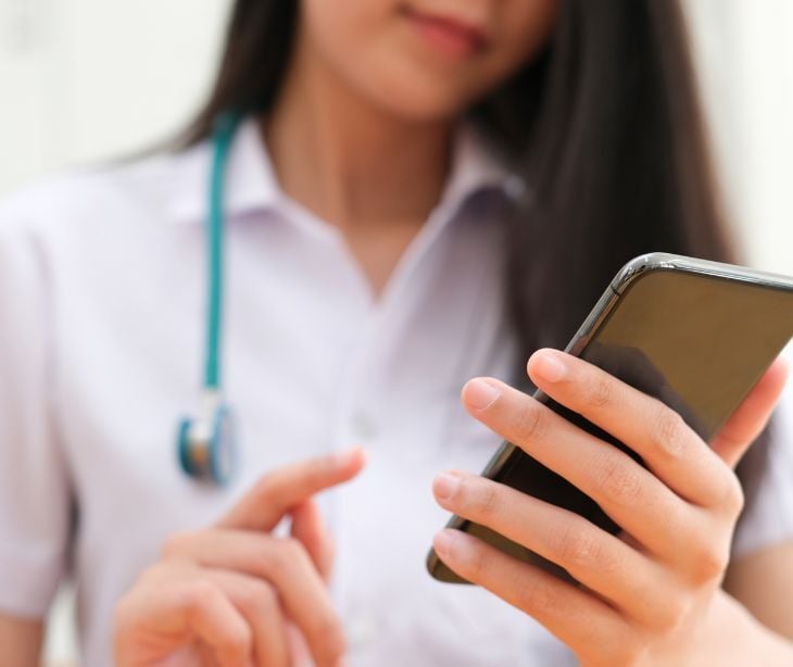 medical provider holding smartphone