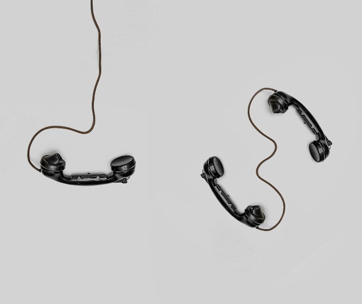 Image of three telephones and their wires. 