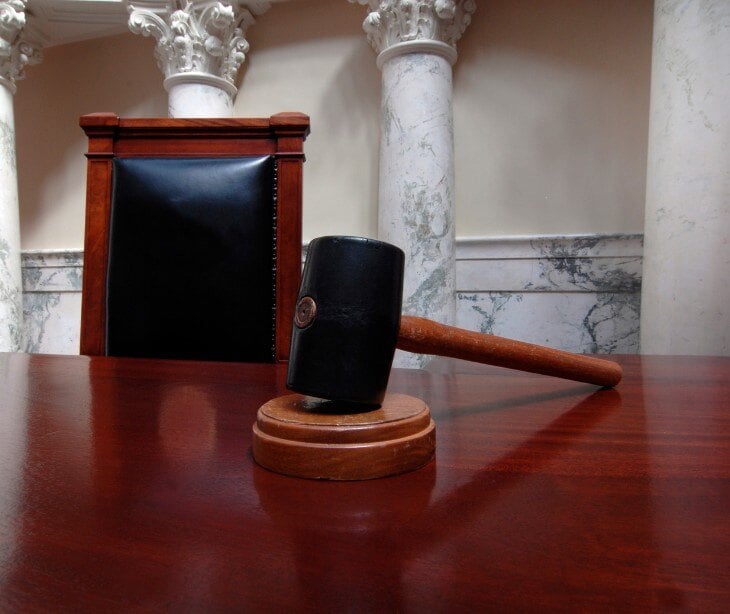 Image of gavel in a court room.