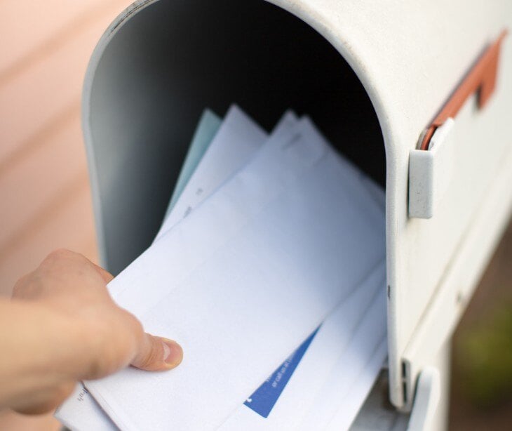 Image of someone putting in a letter