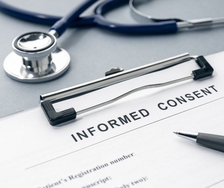 informed consent form on clipboard with stethoscope