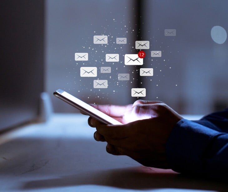 Image of someone reading emails on their phone. 