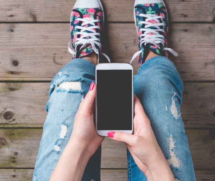Image of someone looking at their smart phone. 
