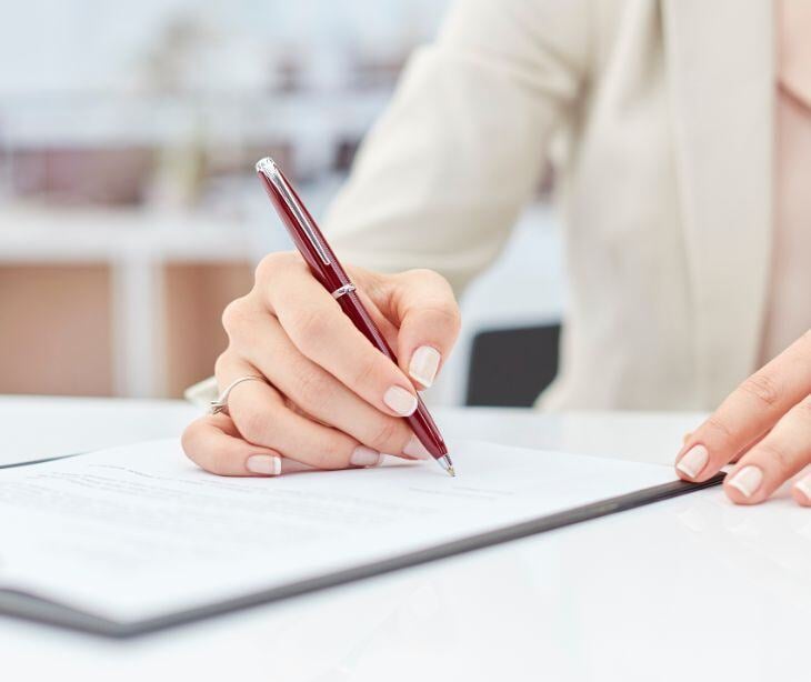 woman signing papers