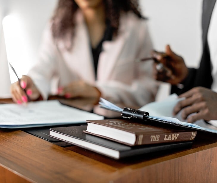 Image of two people discussing legal documents.
