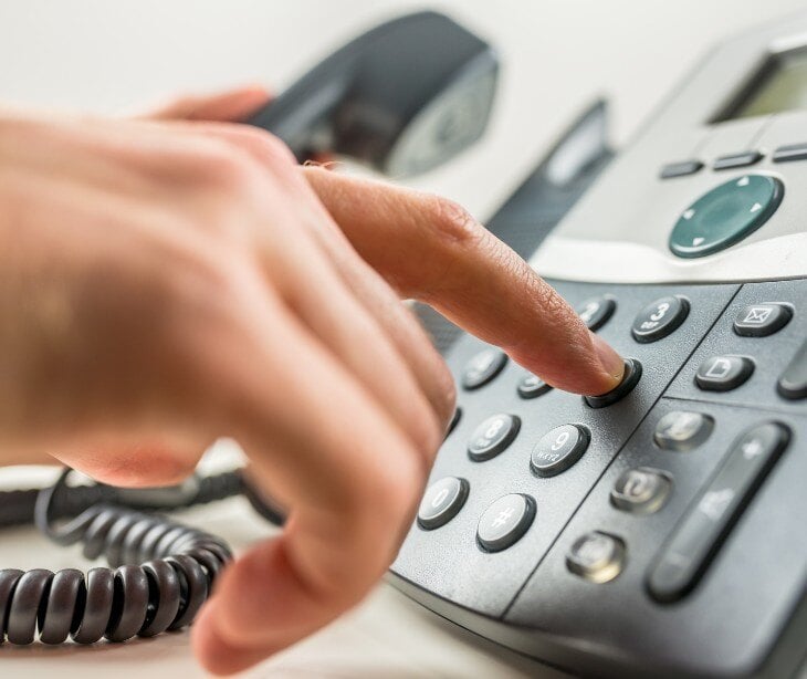 Image of someone dialing a phone for blog about Can healthcare organizations share a patients information with a caller