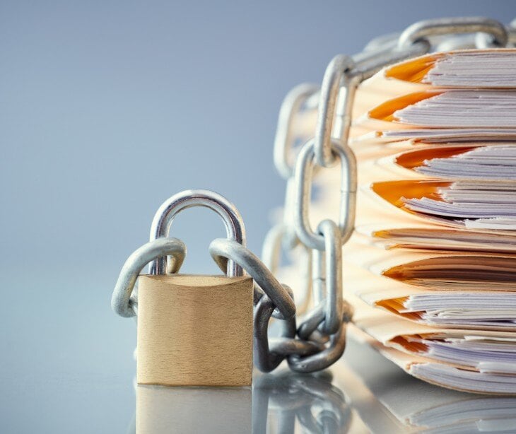 Image of files under a lock for blog about Breaking confidentiality to meet legal obligations