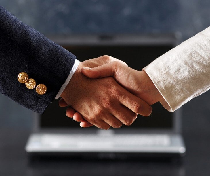 Two individuals shaking hands for blog about Understanding covered entities’ responsibilities toward business associates under HIPAA