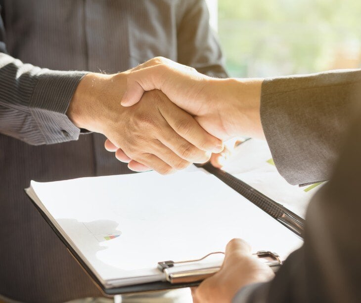 Image of two people shaking hands for blog about Incidental PHI exposure and business associate agreements