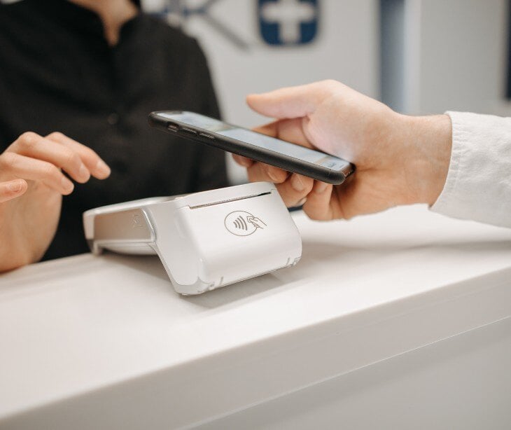 Image of someone using a tap to pay machine for blog about Laredo lawsuit challenges Medicaid eligibility DSH payments