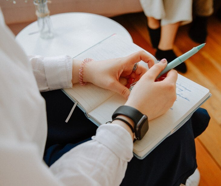 Image of someone taking notes for blog about The role of mental health practitioners in community systems of care for children