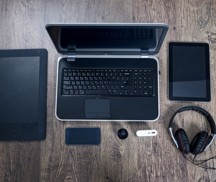 Image of several electornic devices, like a laptop and phone, for blog about Acceptable use policies (AUP) and HIPAA compliance