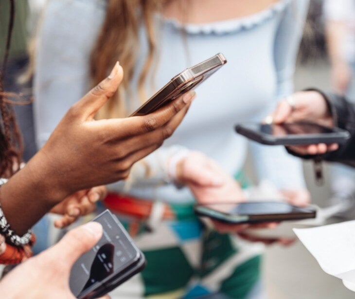 Image of people on their phones for blogs about Social media HIPAA violations