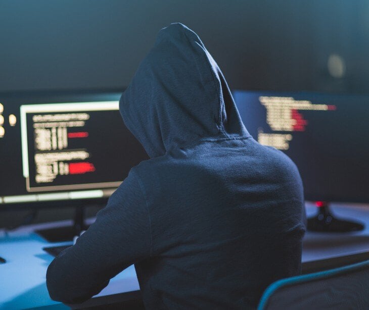 Image of someone hacking into a computer for blog about What is a Smurf attack?