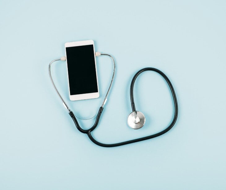 Image of phone with stethescope for blog about HIPAA compliant patient follow-up in telehealth