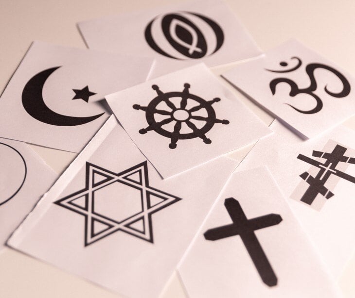 Image of religious symbols for blog about How belief systems and religion should factor into written communications 