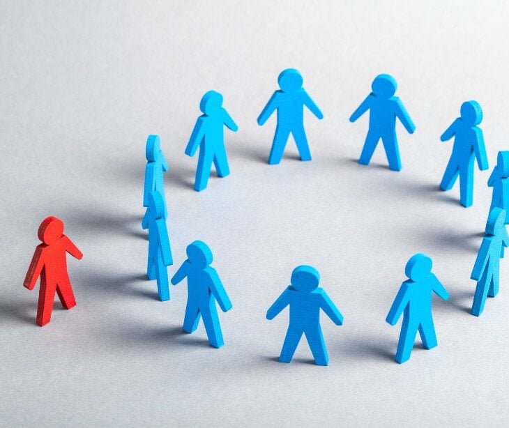 Image of stick figures excluding another figure for blog about Addressing implicit biases in email communication