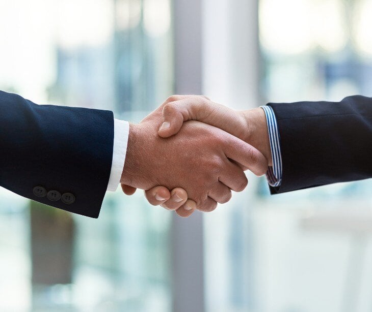 Image of individuals shaking hands for blog about Understanding BAA compliance in healthcare