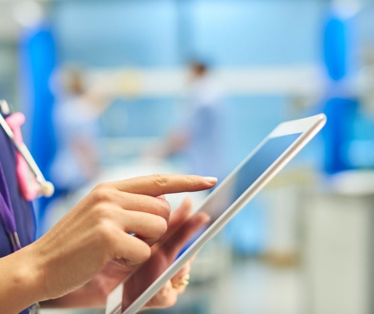 female provider hand on tablet