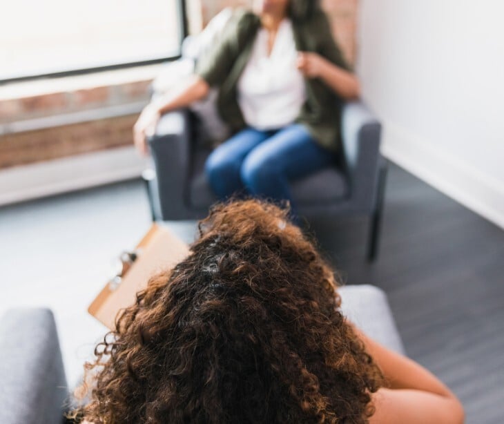 Image of a counselor talking to a patient. 