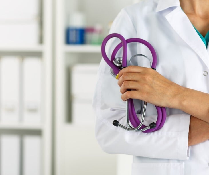Image of a physician holding a stethascope. 