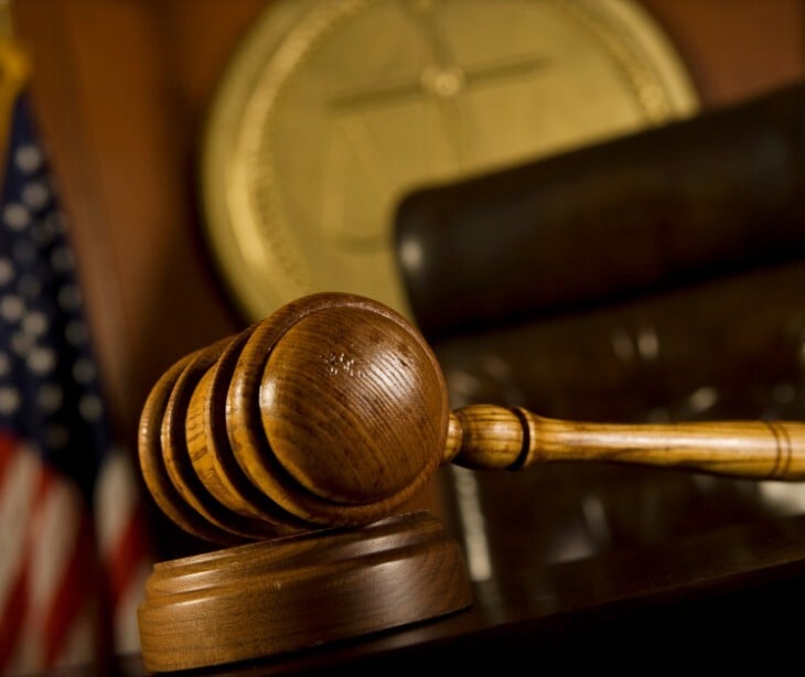 Image of a gavel in a courtroom.