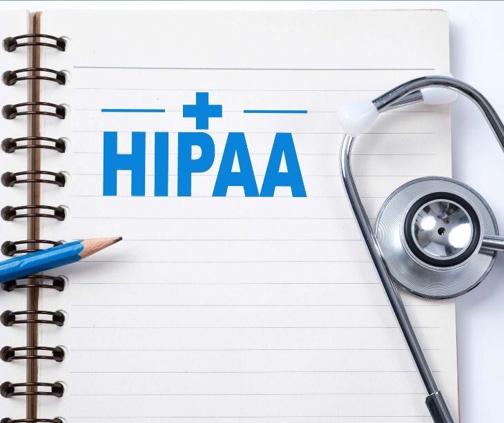 pad and pencil with stethoscope HIPAA text