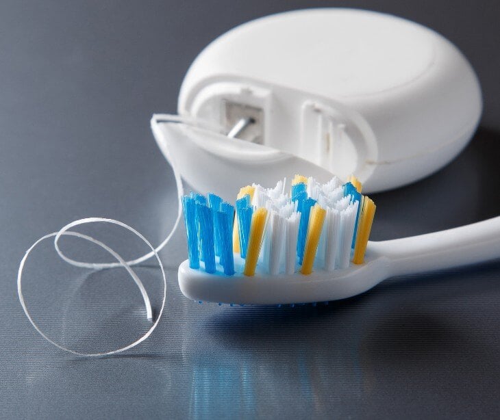 Image of toothbrush and floss for blog about The ethical implications of using AI in dental diagnosis