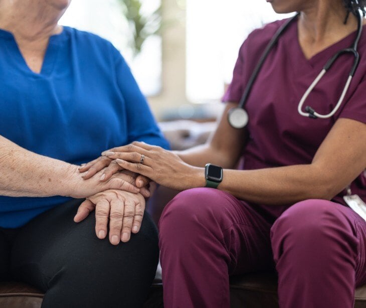 Image of nurse talking to elderly patient.