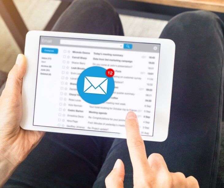 Image of someone checking their email for blog about The implications of non-HIPAA compliant communication in healthcare
