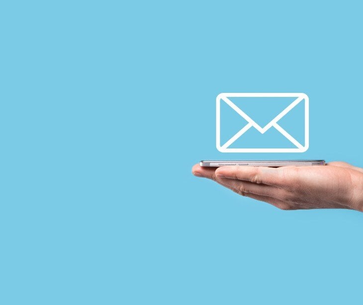Image of someone holding out their hand with an email icon.