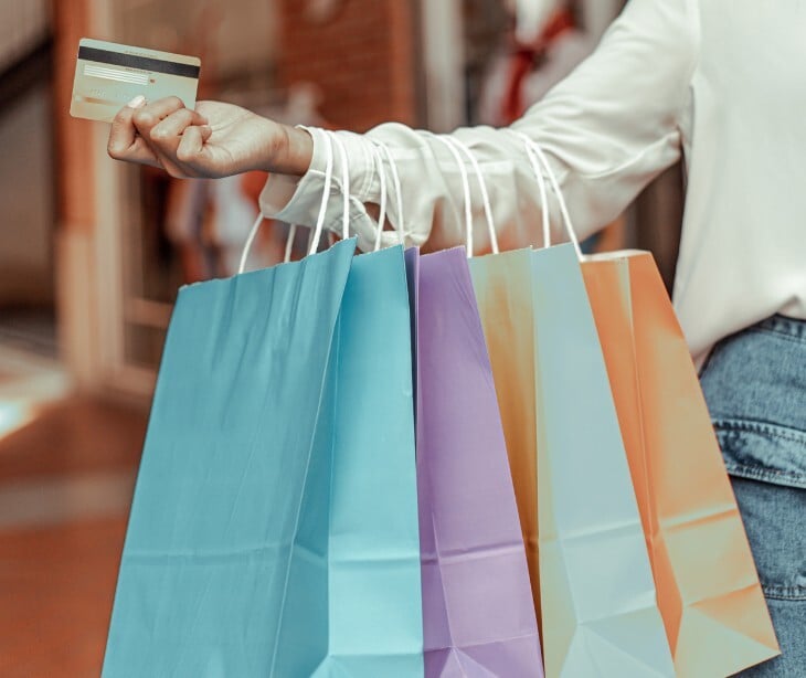Image of someone carrying shopping bags. 